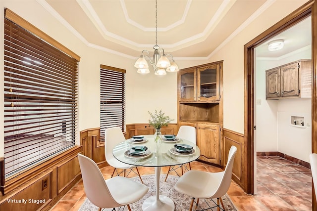 115 Spence Dr, Wylie, TX 75098 - dining space with wainscoting, a raised ceiling, a notable chandelier, and light tile patterned floors