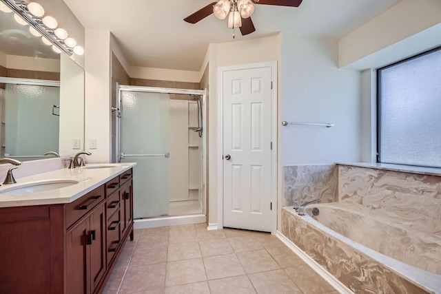 bathroom with a garden tub, a stall shower, a sink, and tile patterned floors