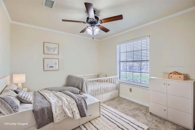 bedroom featuring light carpet, ceiling fan, ornamental molding, and visible vents