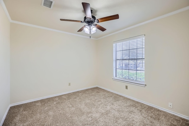 carpeted spare room with baseboards, visible vents, and crown molding