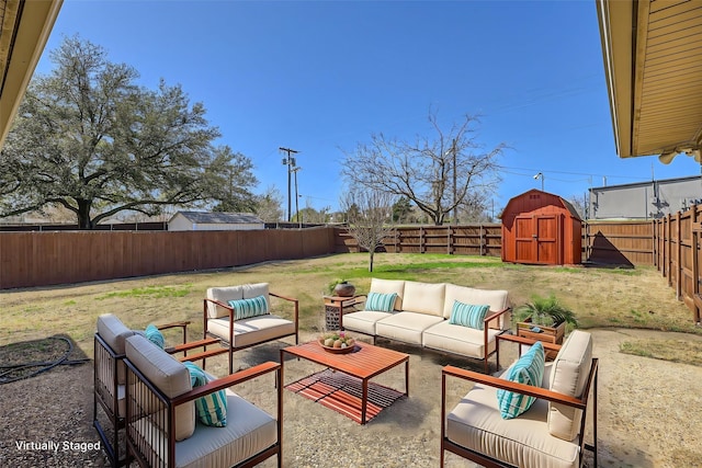 view of patio / terrace featuring a fenced backyard, a storage unit, outdoor lounge area, and an outdoor structure