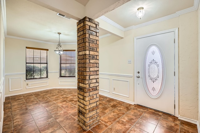 115 Spence Dr, Wylie, TX 75098 - tiled foyer entrance featuring decorative columns, visible vents, a decorative wall, wainscoting, and ornamental molding