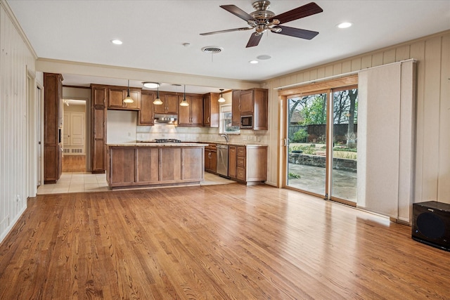 kitchen with visible vents, stainless steel appliances, light wood-type flooring, and light countertops