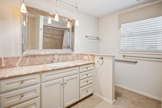 bathroom with tile patterned floors, curtained shower, vanity, and baseboards