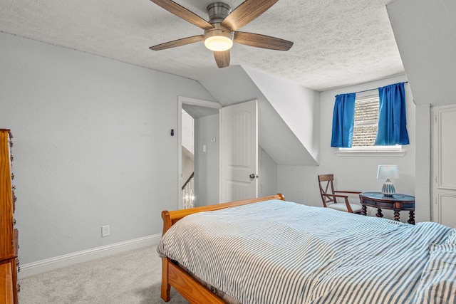 bedroom featuring lofted ceiling, a textured ceiling, carpet flooring, baseboards, and ceiling fan