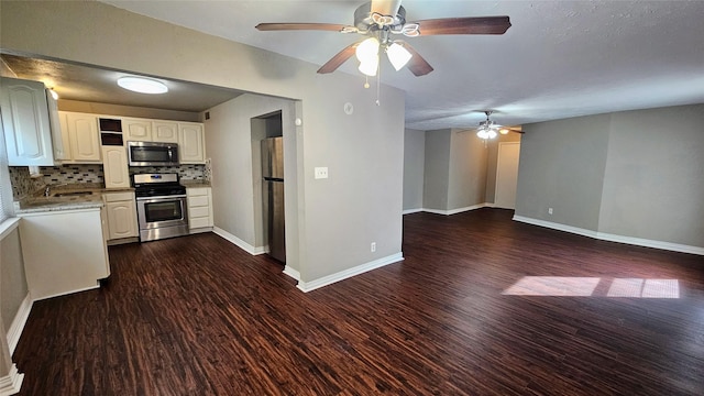 kitchen featuring dark wood-style floors, stainless steel appliances, baseboards, and decorative backsplash