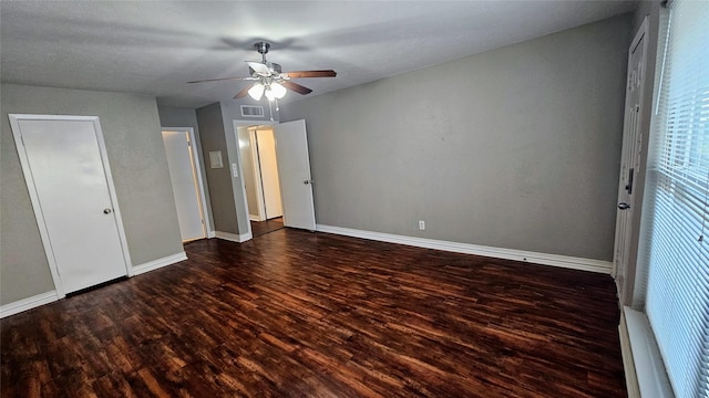 unfurnished bedroom featuring visible vents, ceiling fan, baseboards, and wood finished floors