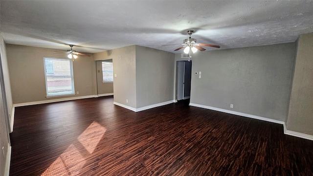 empty room with dark wood-style floors, baseboards, and a ceiling fan