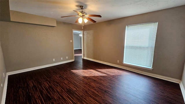 unfurnished room featuring ceiling fan, baseboards, and wood finished floors