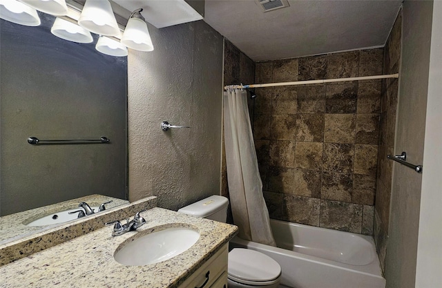 bathroom featuring visible vents, a textured wall, toilet, shower / tub combo with curtain, and vanity