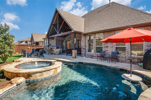 view of pool featuring outdoor dry bar, a pool with connected hot tub, an outdoor fire pit, a patio area, and fence