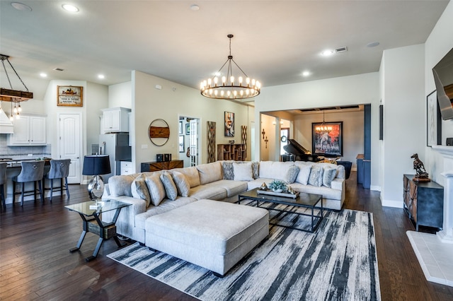 living room with recessed lighting, a notable chandelier, dark wood-style flooring, visible vents, and baseboards