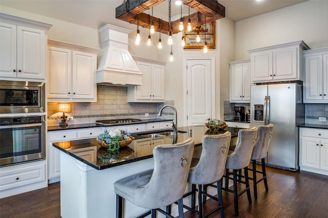 kitchen featuring stainless steel appliances, dark wood finished floors, custom range hood, and a sink