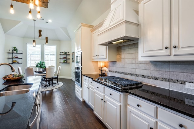 kitchen with dark wood-style flooring, a sink, appliances with stainless steel finishes, backsplash, and custom exhaust hood