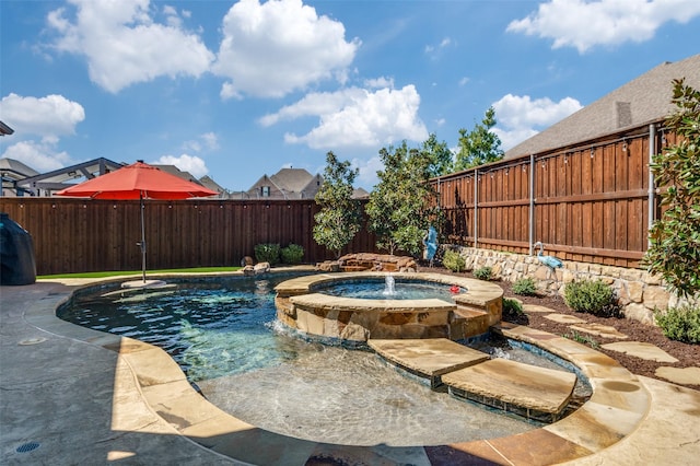 view of swimming pool featuring a fenced backyard and a pool with connected hot tub