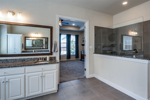 bathroom with baseboards, tile patterned floors, walk in shower, vanity, and recessed lighting