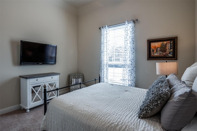 carpeted bedroom featuring baseboards