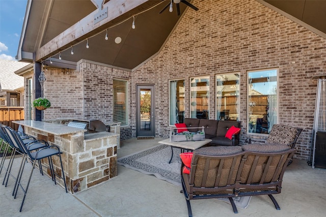 view of patio / terrace featuring an outdoor living space, a grill, and outdoor wet bar