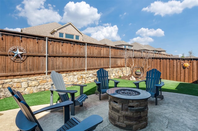 view of patio / terrace with a fire pit and a fenced backyard