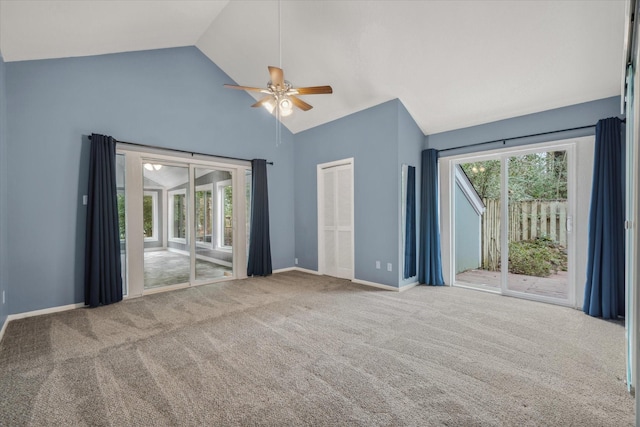 interior space featuring carpet floors, a healthy amount of sunlight, high vaulted ceiling, and baseboards