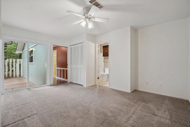 unfurnished bedroom featuring ensuite bath, access to outside, visible vents, and carpet flooring