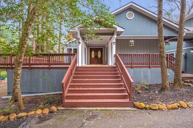 view of front of property featuring stairway and a wooden deck