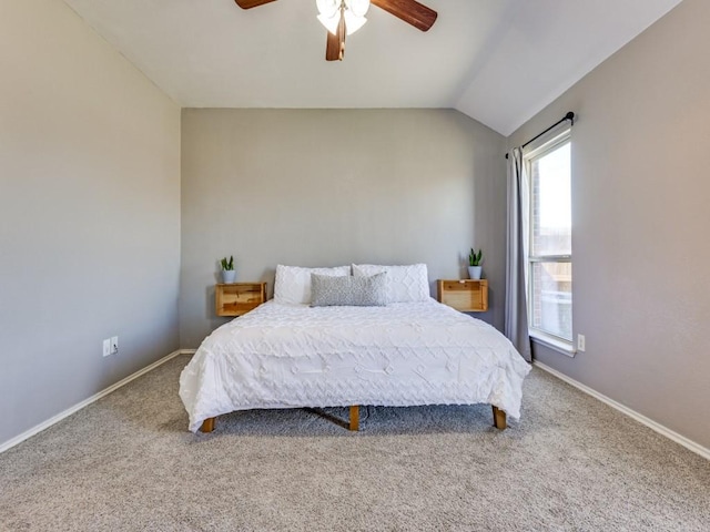 bedroom with lofted ceiling, baseboards, ceiling fan, and carpet