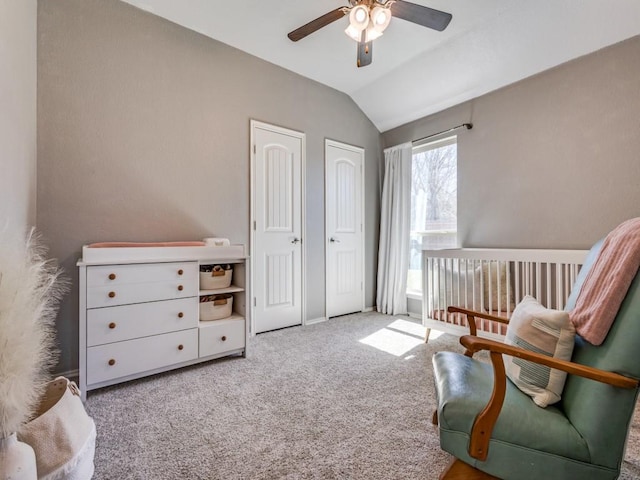 living area with lofted ceiling, carpet floors, and ceiling fan