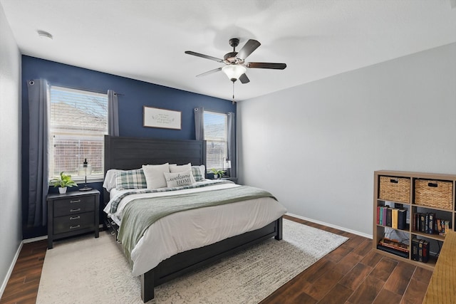 bedroom with a ceiling fan, baseboards, and wood finished floors