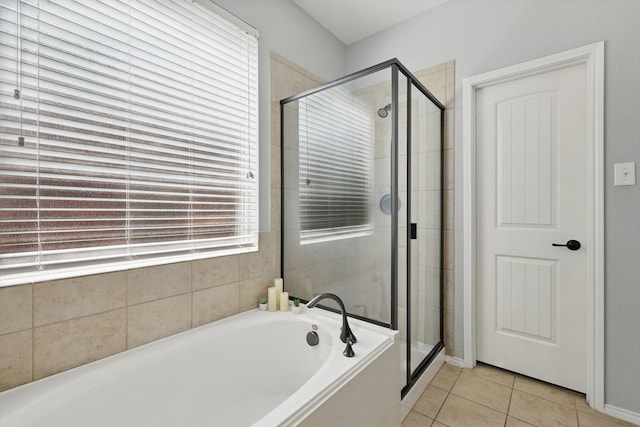 full bath featuring a stall shower, a bath, and tile patterned floors