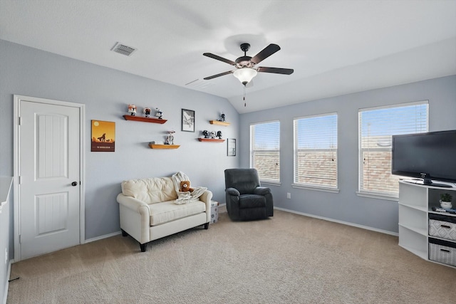 sitting room featuring carpet, visible vents, plenty of natural light, and lofted ceiling