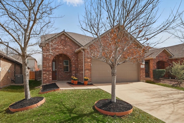 view of front of home featuring a garage, central AC, brick siding, driveway, and a front lawn