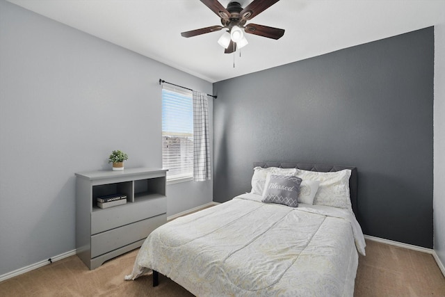 bedroom with ceiling fan, baseboards, and carpet flooring