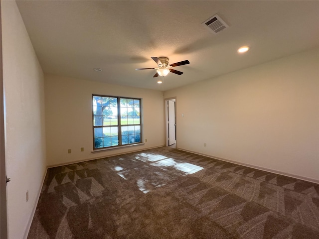 unfurnished room featuring a ceiling fan, carpet, visible vents, and baseboards