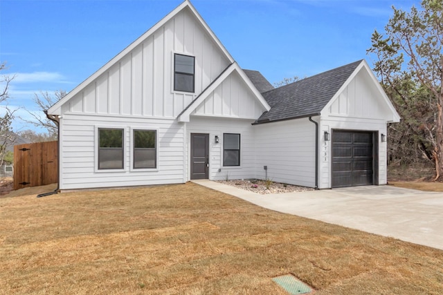 modern farmhouse featuring a garage, driveway, roof with shingles, board and batten siding, and a front yard