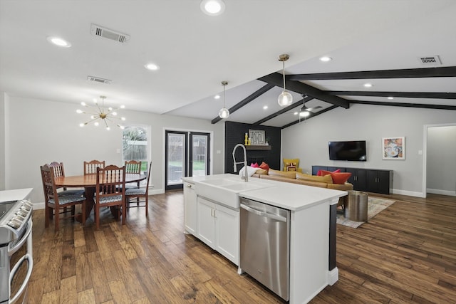 kitchen featuring lofted ceiling with beams, visible vents, stainless steel appliances, and a sink