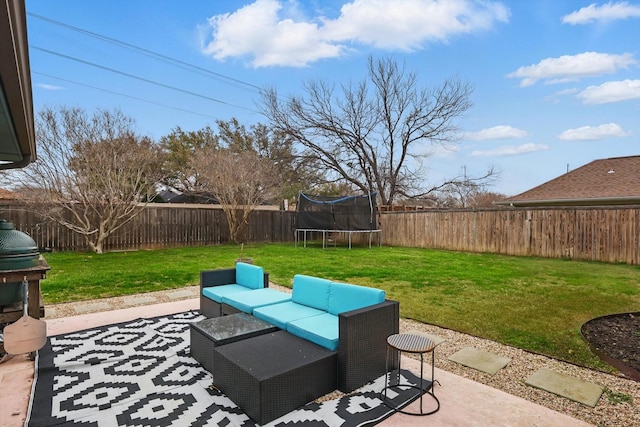 view of patio with a trampoline, a fenced backyard, and an outdoor living space