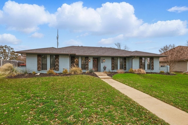 single story home with brick siding, a front lawn, and a shingled roof