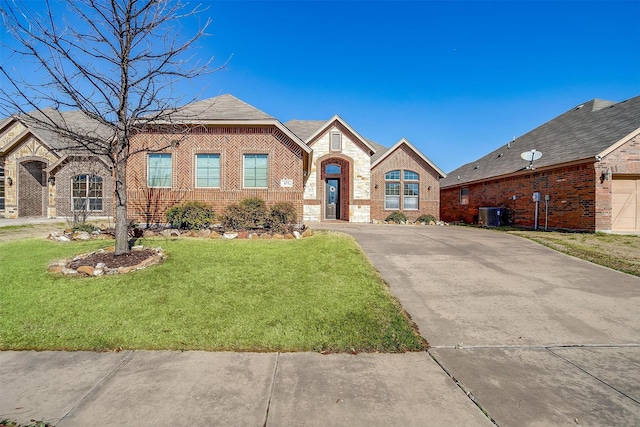 view of front of house featuring central AC, brick siding, a front lawn, and driveway