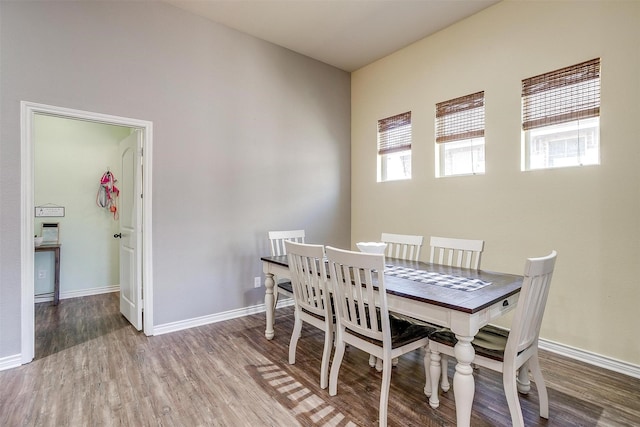 dining room with baseboards and wood finished floors