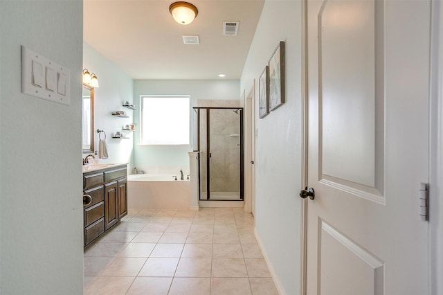 full bathroom with visible vents, tile patterned floors, a garden tub, vanity, and a shower stall