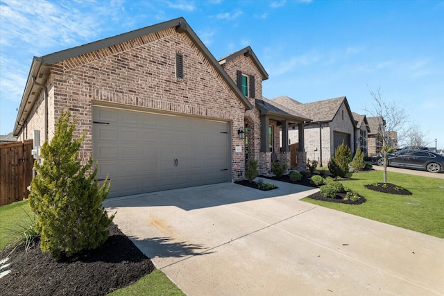 view of front of house featuring fence, driveway, an attached garage, a front lawn, and brick siding