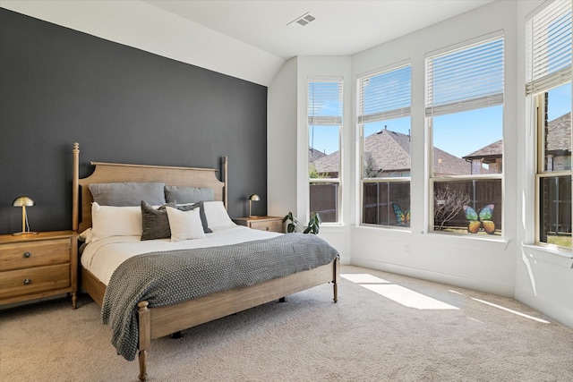 carpeted bedroom featuring baseboards and visible vents