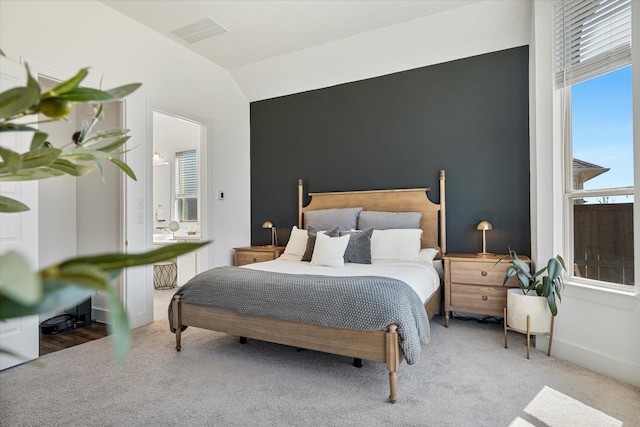 carpeted bedroom with visible vents, baseboards, and vaulted ceiling