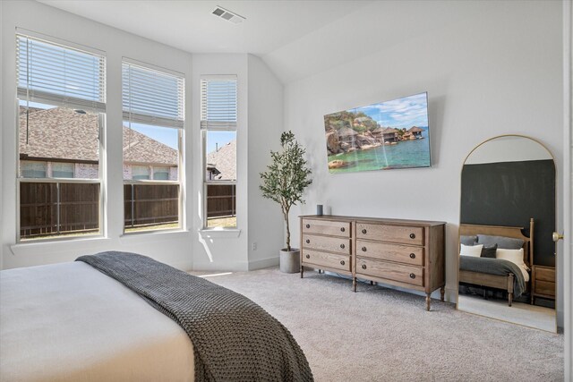 carpeted bedroom featuring visible vents and baseboards