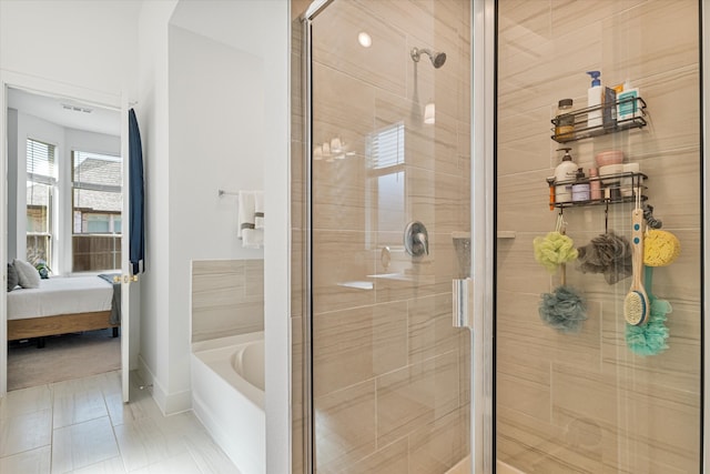 bathroom with connected bathroom, baseboards, a bath, and a shower stall