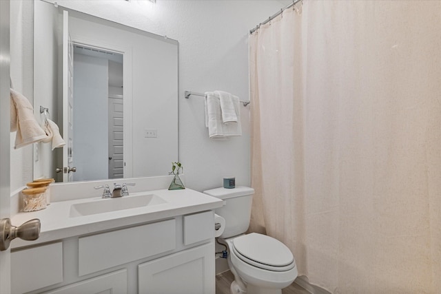 full bathroom with toilet, vanity, a shower with curtain, and wood finished floors