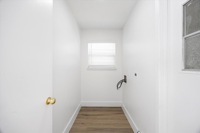 clothes washing area with hookup for a washing machine, laundry area, wood finished floors, baseboards, and electric dryer hookup