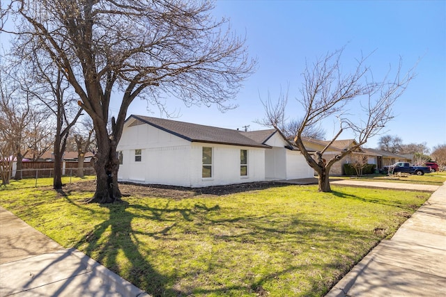 view of property exterior with a garage, driveway, fence, a yard, and brick siding