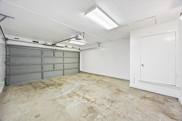 garage with baseboards and a garage door opener